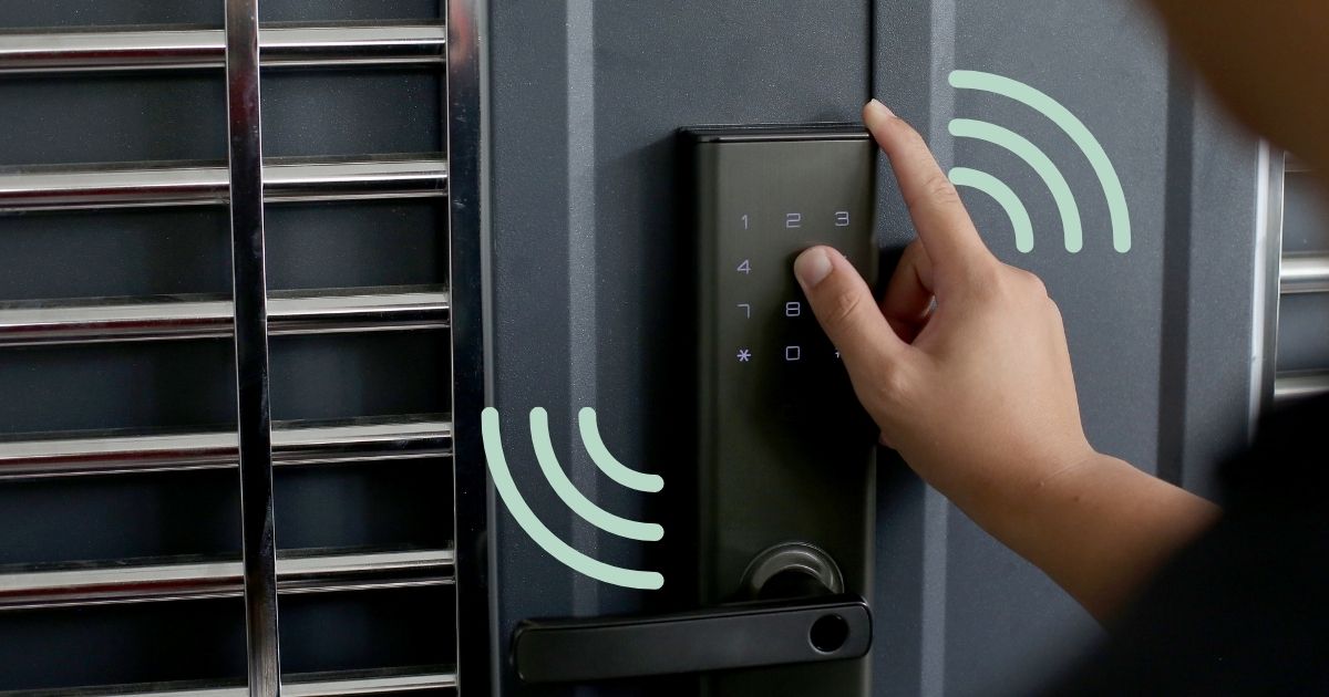 Image of person's hand unlocking a smart lock