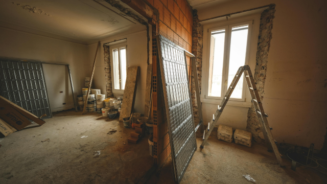 Room mid-renovation with ladders and drop cloths during smart home upgrade