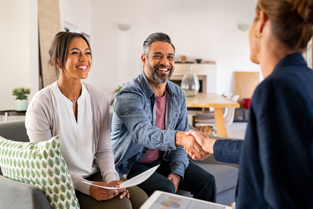 woman shaking hands with male client